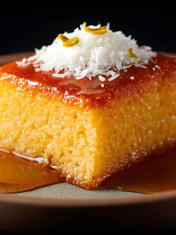 closeup of spanish caramel cake with coconut flakes on top