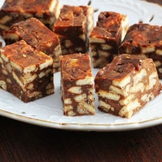 Spanish Chocolate Biscuit Cake cut into pieces on a white plate