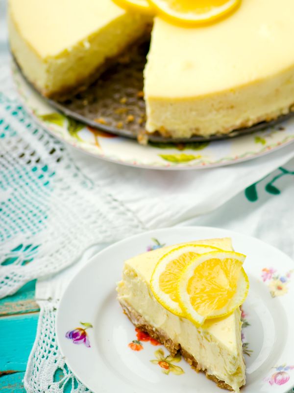 Tarta de Limon on a plate with a slice being cut from the round one - Irresistible Tarta De Limón Recipe