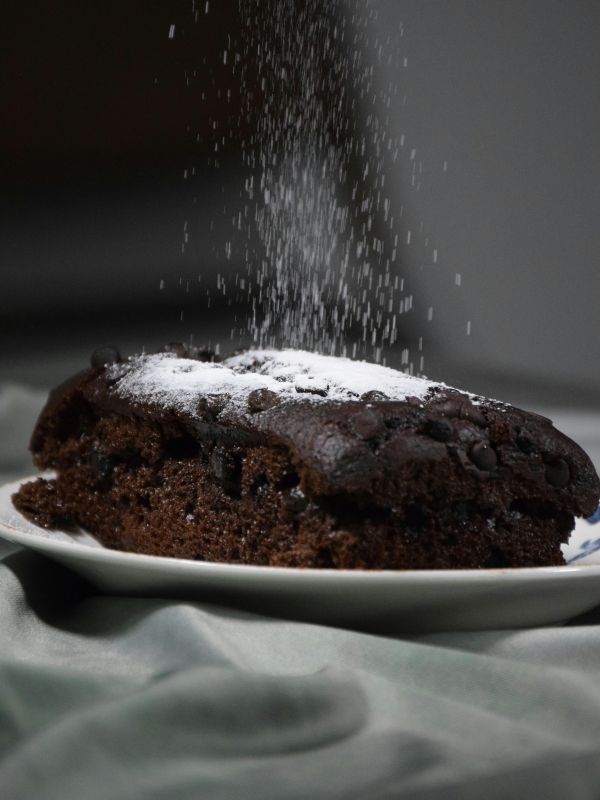 a slice of spanish chocolate cake dusted with powdered sugar