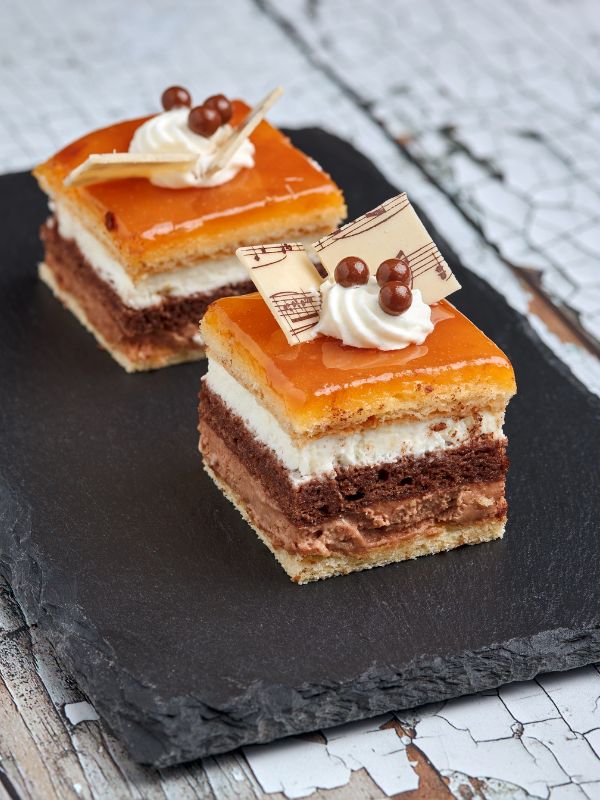 layered cake known as tarta san marcos on a black plate - Best Tarta San Marcos Recipe