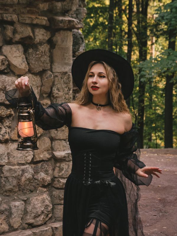 a girl dressed as a witch and holding a light in one of the Unusual Villages in Andalucia