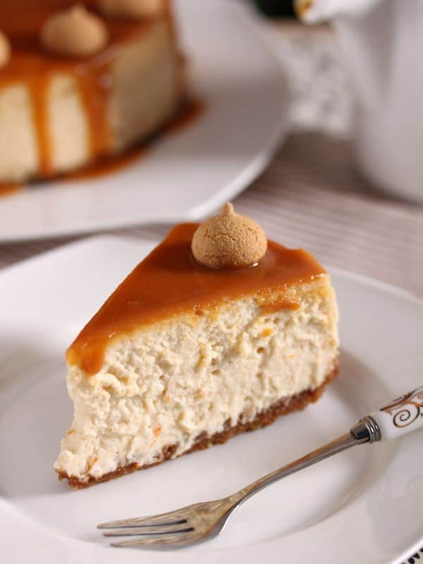 slice of dulce de leche cheesecake on a white plate