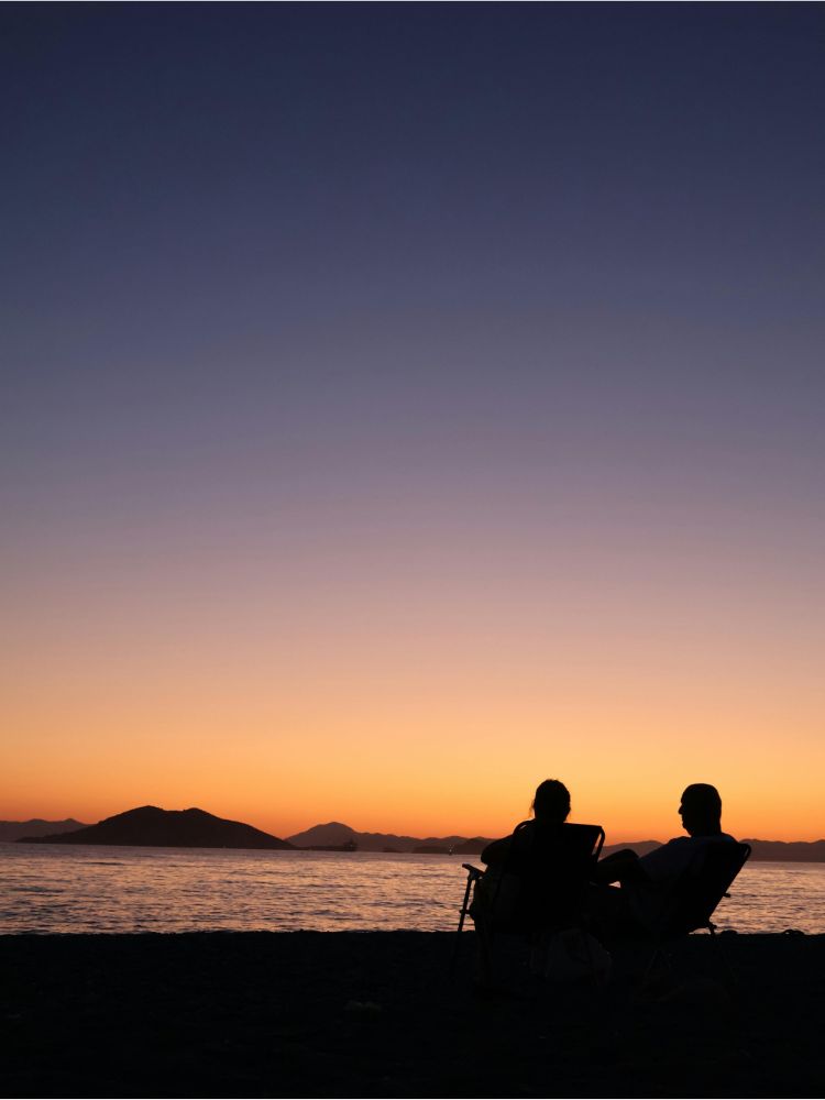 a couple relaxing by the beach, Reasons why you must Visit South Spain