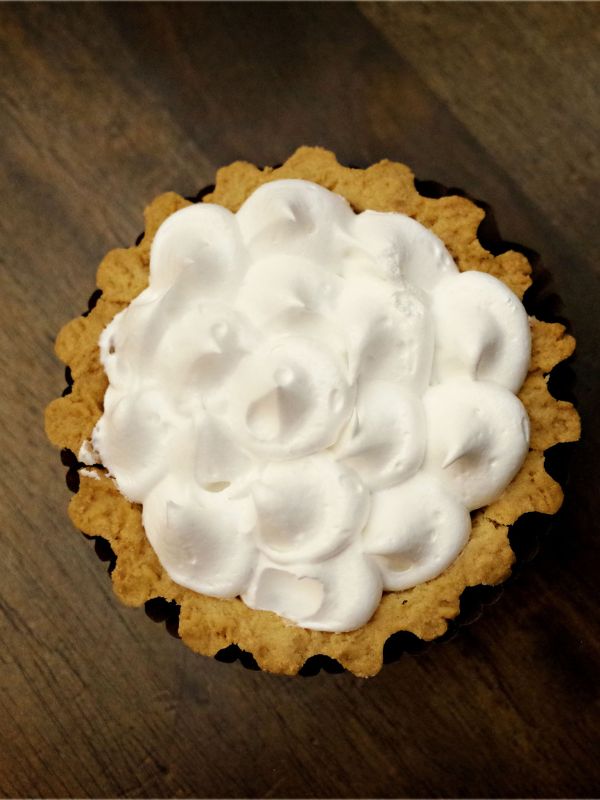 Dulce de leche tart decorated with whipped cream