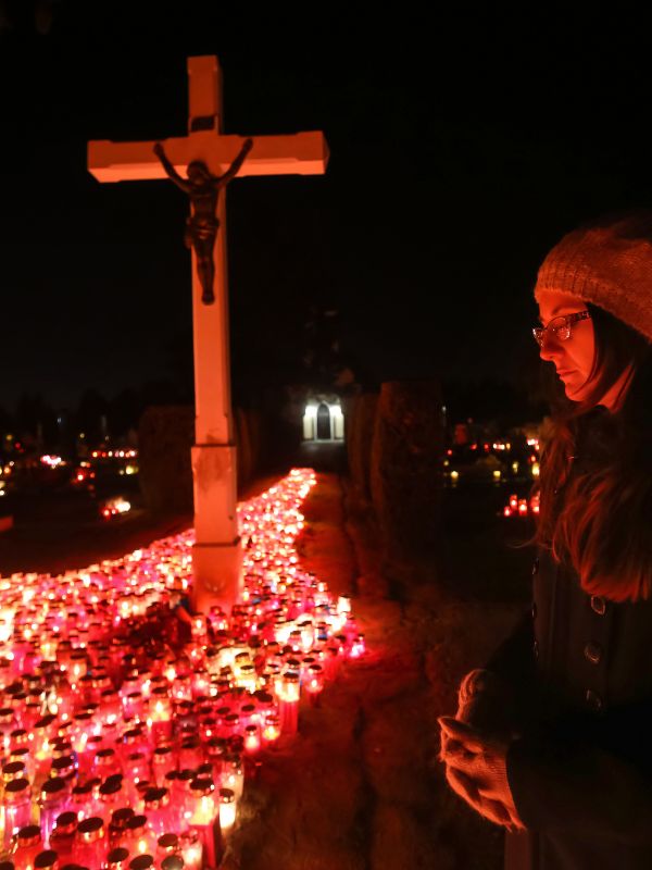 woman paying respects in a cemetery for Halloween in Andalucia